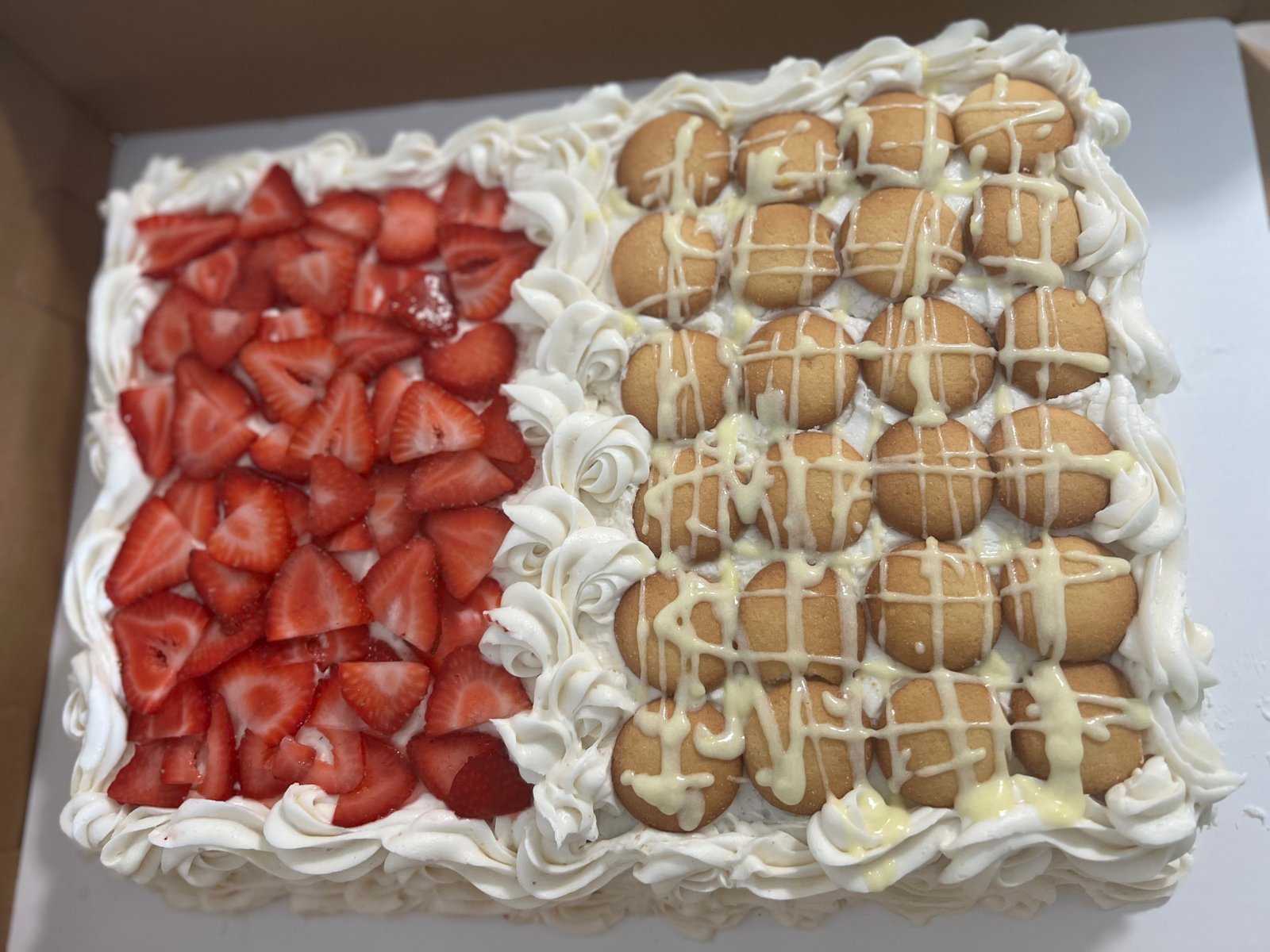 Strawberry banana pudding sheet cake with fresh strawberries and vanilla wafers